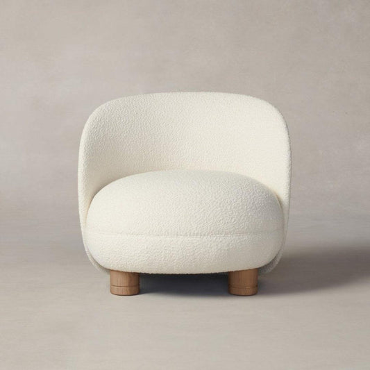 Front view of the Dima Boucle Armchair with soft boucle fabric upholstery and wooden legs, perfect for cozy and modern living spaces.