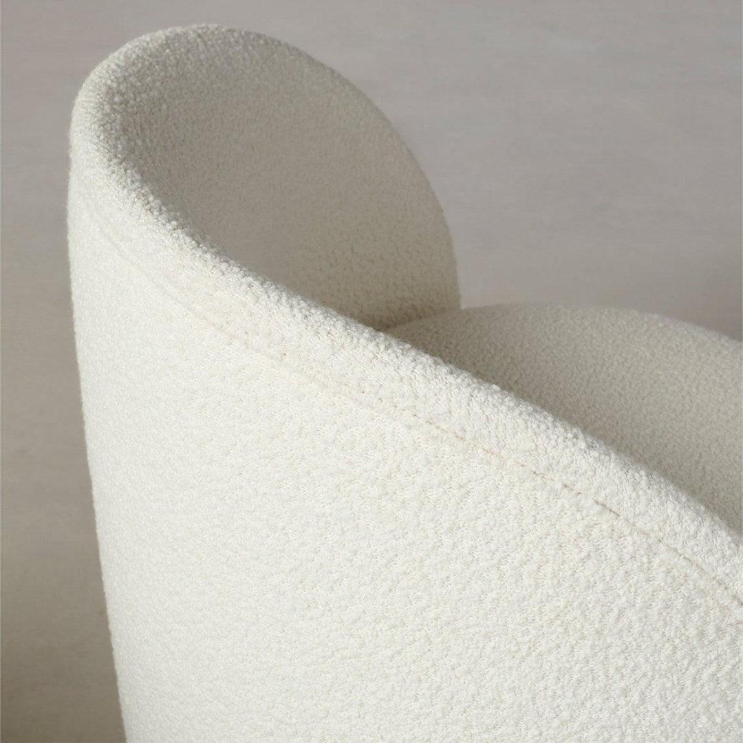 Close-up of the Dima Boucle Armchair backrest with soft boucle fabric, showcasing its elegant curves and premium craftsmanship for modern interiors.