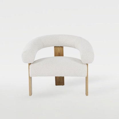Polly Wooden Leg Armchair with boucle fabric and unique wooden leg design, styled in a modern interior, perfect for elegant and cozy living spaces.