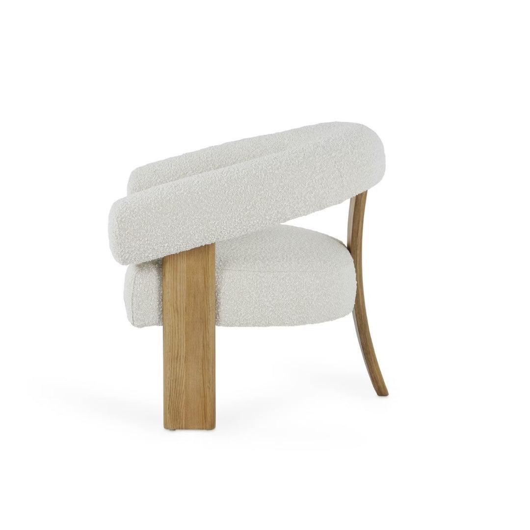 Polly Wooden Leg Armchair in boucle fabric with unique wooden legs, styled in a bright, modern interior, perfect for contemporary living spaces in UAE