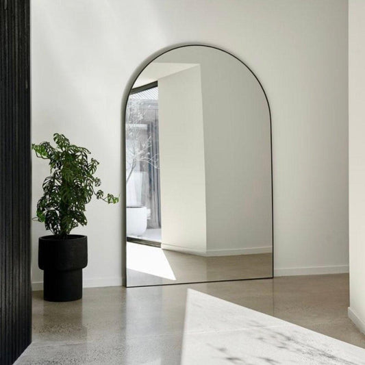 Elegant Kylie arch mirror with sleek black aluminum frame in a modern interior, perfect for enhancing home décor in Dubai, Sharjah, Ajman, and beyond.