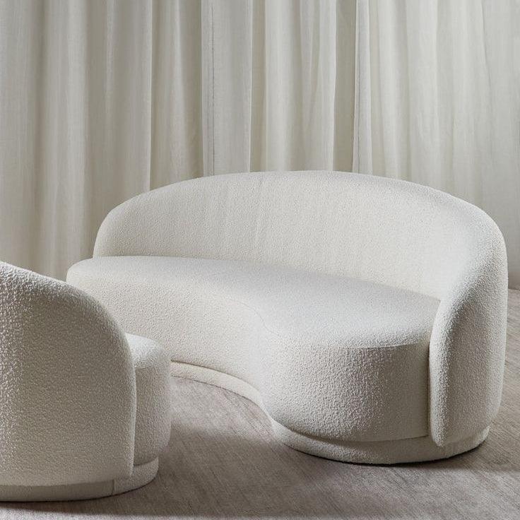 Nara Lounge Sofa in off-white boucle fabric with a curved design, ideal for modern and elegant living rooms in UAE.