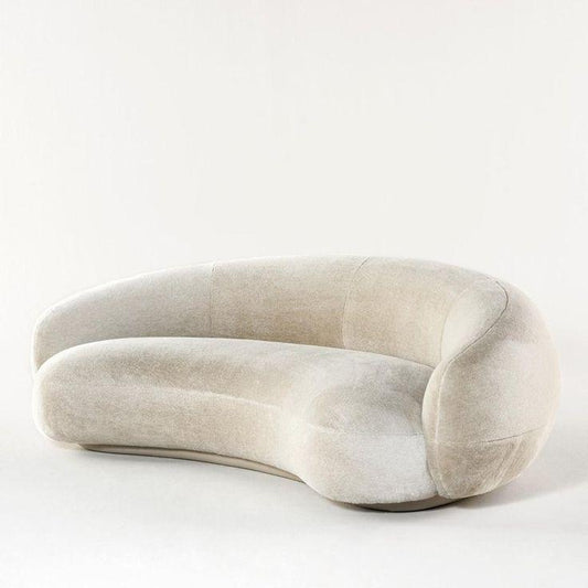 Nara Lounge Sofa with a curved design, upholstered in soft velvet fabric, perfect for modern living rooms and elegant homes in UAE.