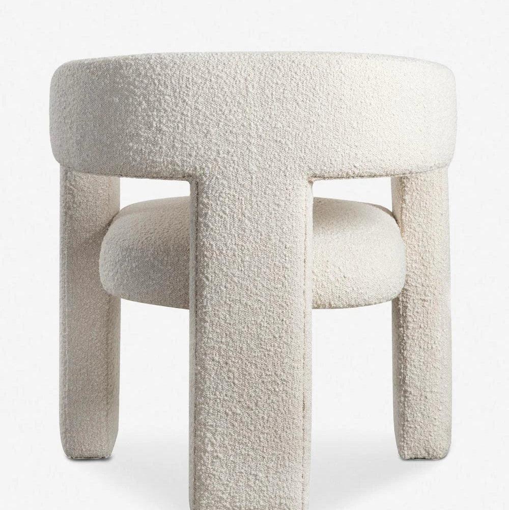 Back view of the Sia Boucle Chair with boucle fabric upholstery and modern curved design, ideal for dining spaces and contemporary interiors.