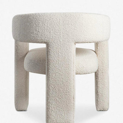 Back view of the Sia Boucle Chair with boucle fabric upholstery and modern curved design, ideal for dining spaces and contemporary interiors.