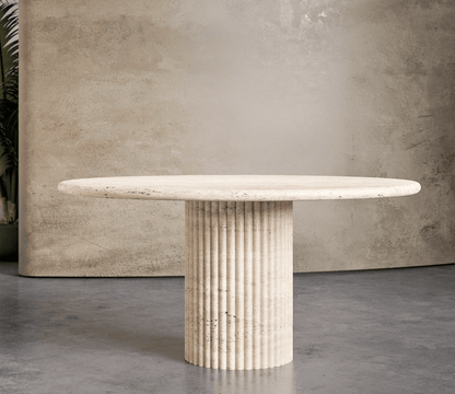 Travertine Marble Dining Table with a fluted pedestal base and round top, showcasing natural beige tones and elegant craftsmanship for UAE dining rooms.