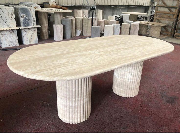 Handcrafted Travertine Marble Dining Table with reeded pedestal bases and an oval top, showcasing natural elegance for luxurious dining spaces.