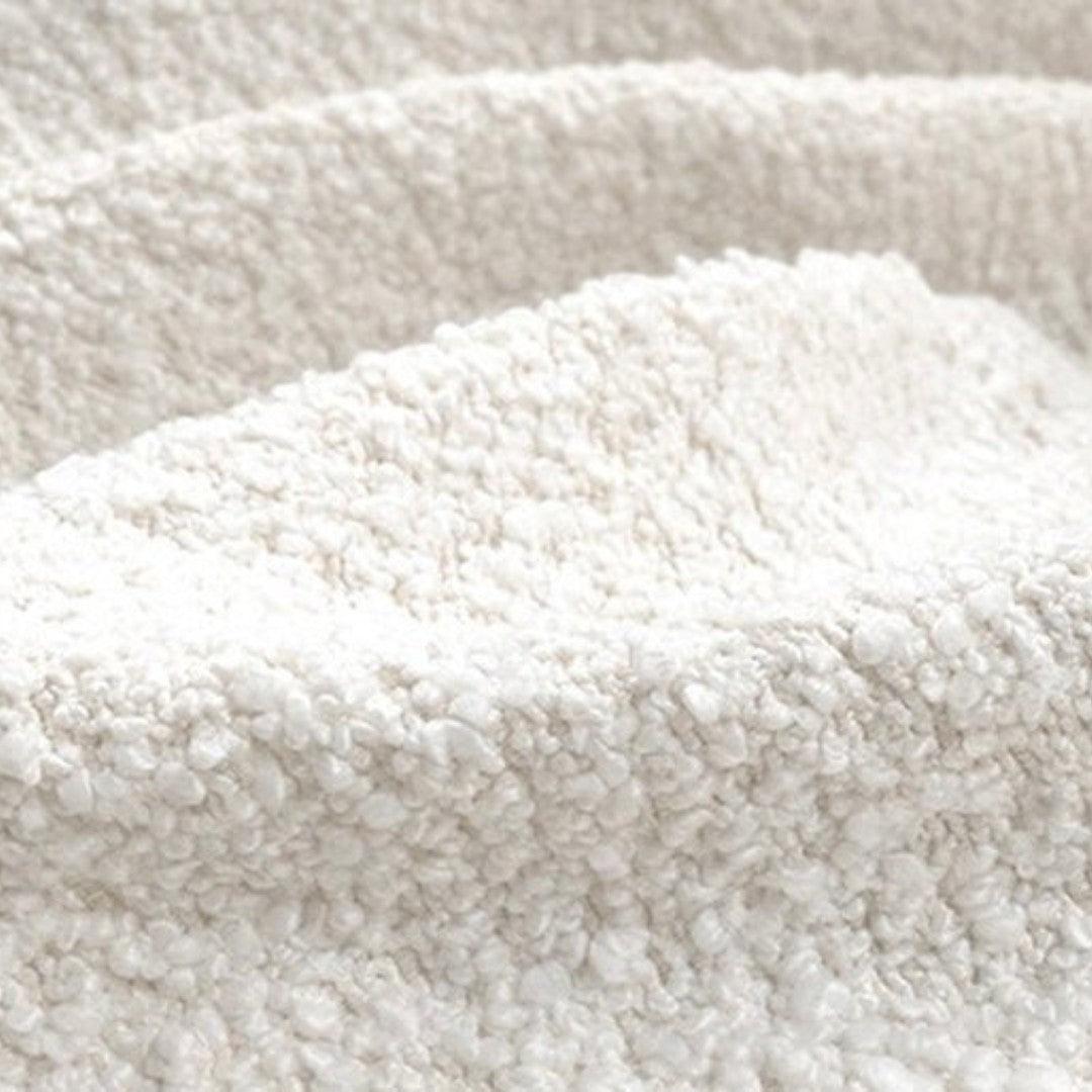 Close-up of boucle fabric upholstery on the Troi Boucle Armchair, showcasing its soft texture and luxurious quality for modern and elegant interiors.