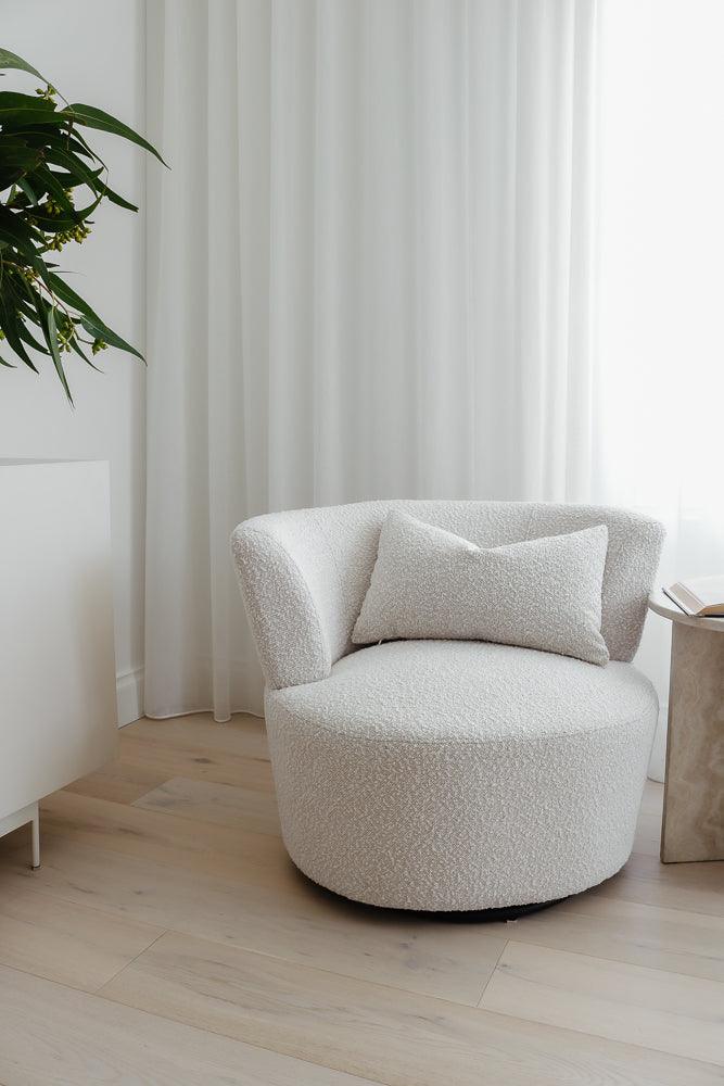 Troi Boucle Armchair in boucle fabric with a round, cloud-like design, styled in a bright and elegant living space, perfect for modern minimalist interiors.