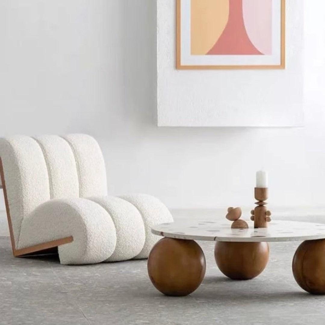Curvy Cloud Accent Chair in white boucle fabric with a wooden back, styled in a modern living room with a marble coffee table and contemporary decor.