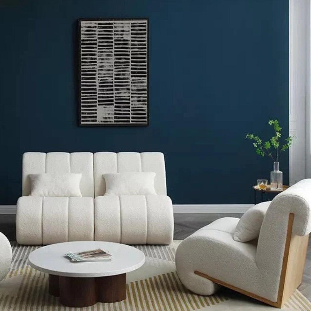 Curvy Cloud Accent Chair in white boucle fabric with a wooden back, styled with matching modern sofas and a round coffee table in a luxury living room.