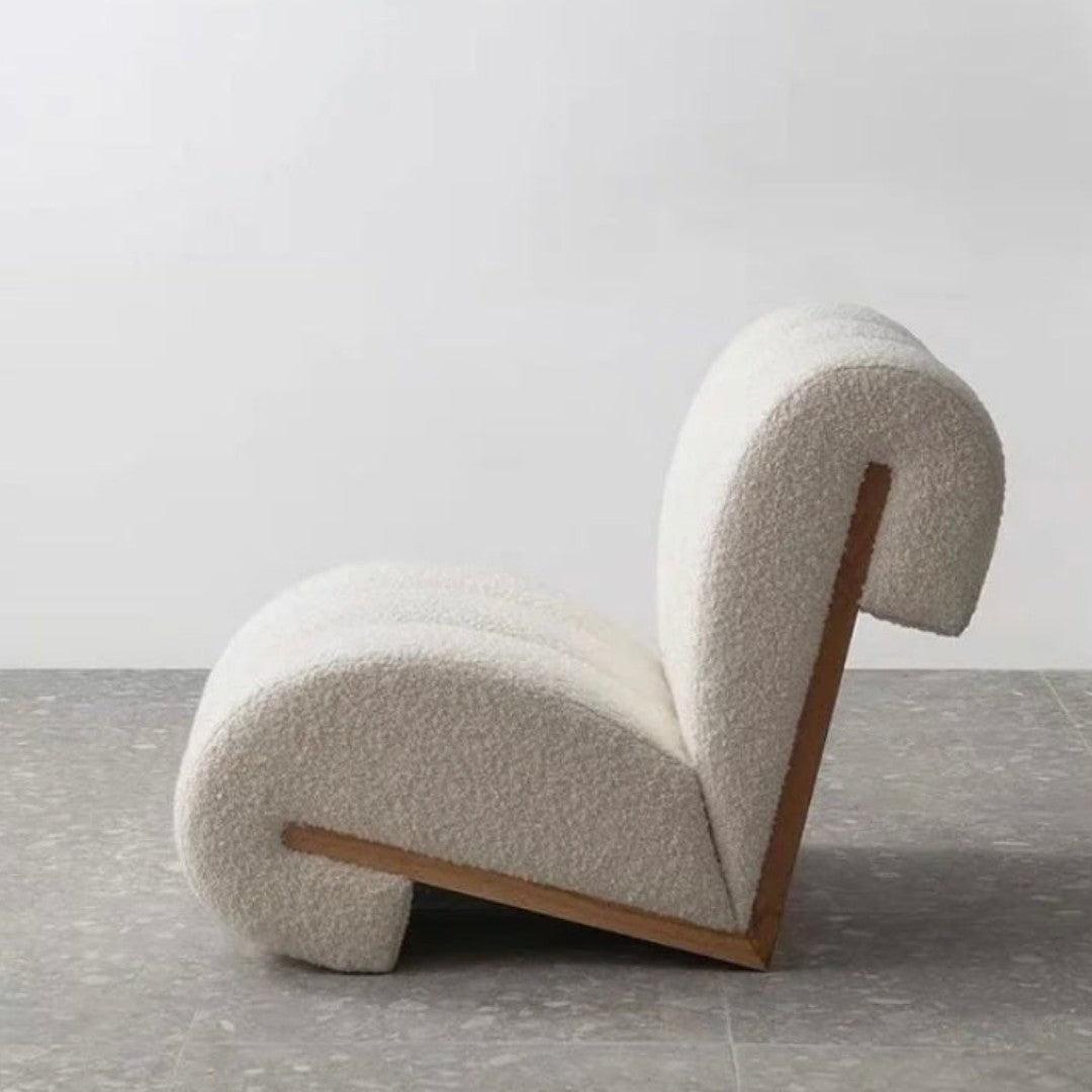 Side view of the Curvy Cloud Accent Chair with boucle fabric and a wooden back, showcasing its bold and modern design, perfect for luxury interiors.