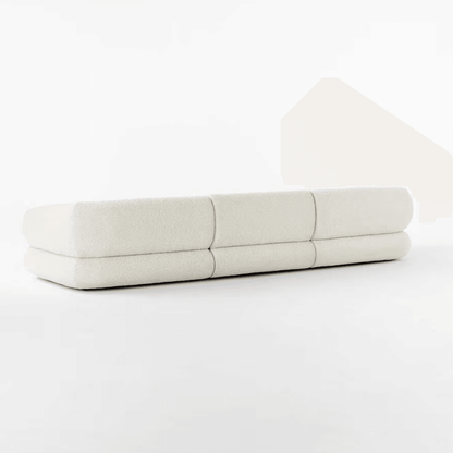 Back view of the Eloise Boucle Sofa in off-white bouclé fabric, showcasing its sculpted base and contemporary design for modern homes in UAE.