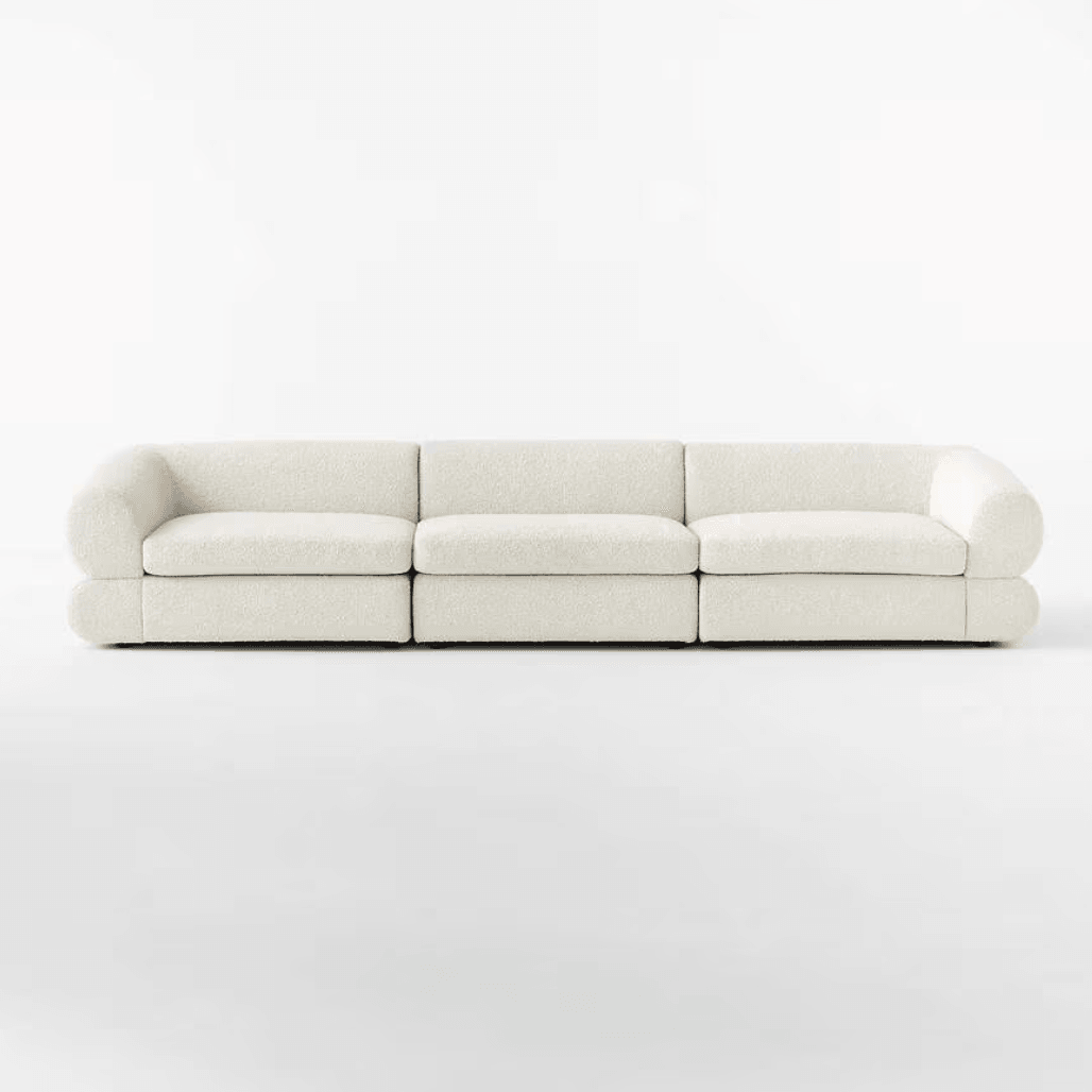 Front view of the Eloise Boucle Sofa in off-white bouclé fabric, featuring a sculpted base and 4-seater design for modern living rooms in UAE.
