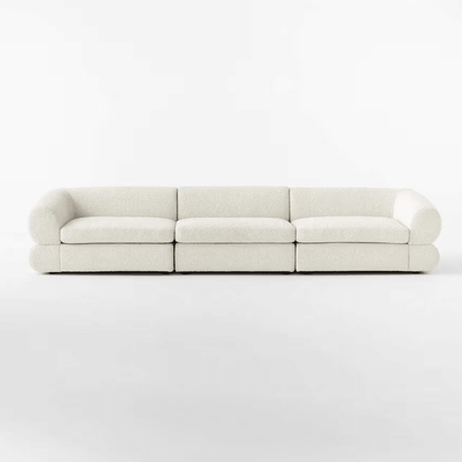 Front view of the Eloise Boucle Sofa in off-white bouclé fabric, featuring a sculpted base and 4-seater design for modern living rooms in UAE.