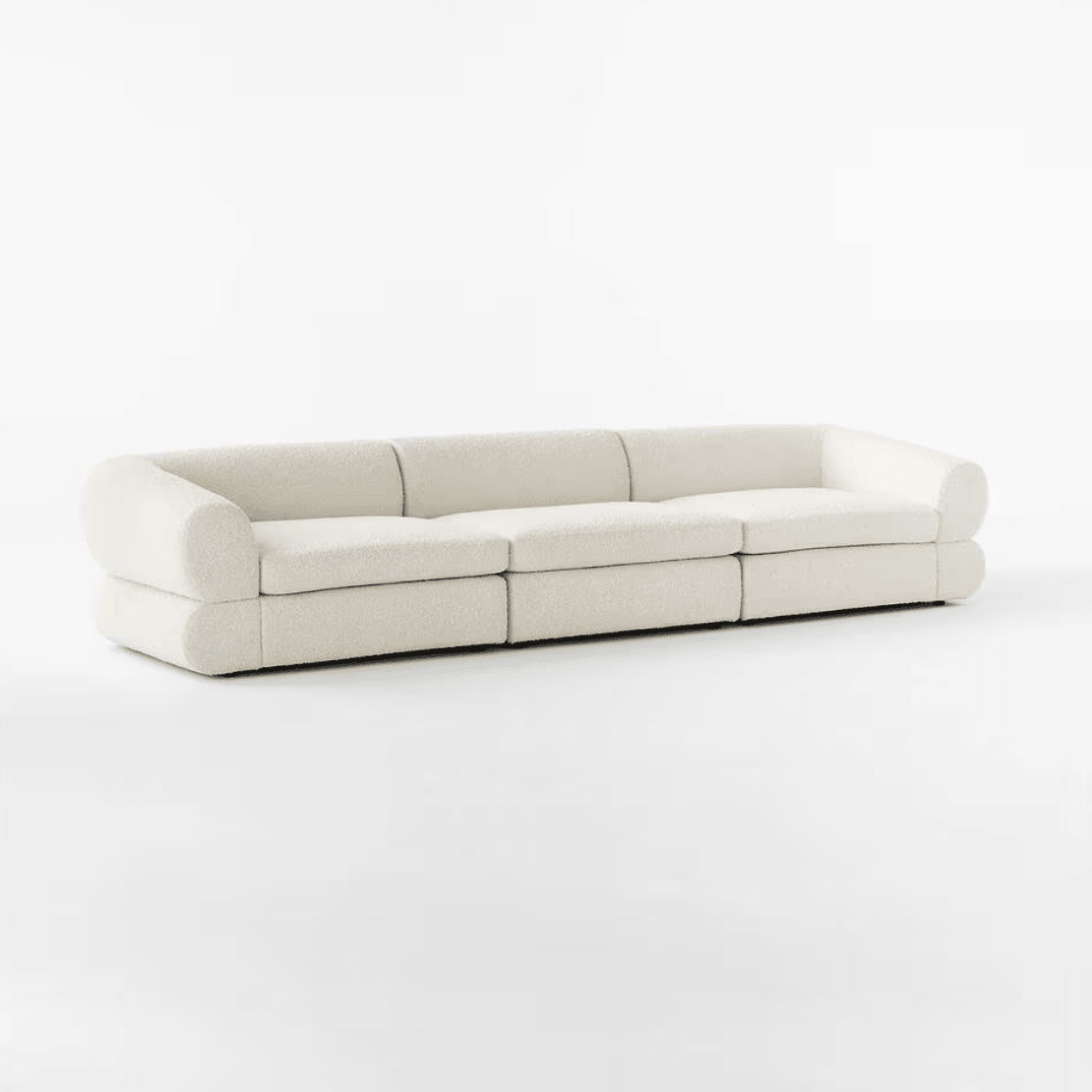 Eloise Boucle Sofa in off-white bouclé fabric with a sculpted base, featuring a 4-seater design perfect for modern and luxurious living rooms in UAE.