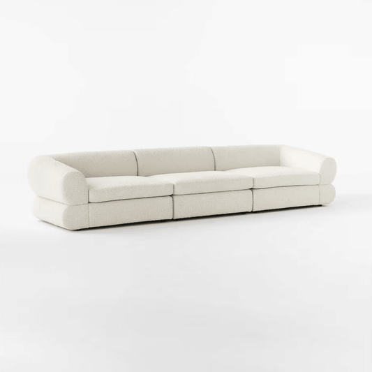 Eloise Boucle Sofa in off-white bouclé fabric with a sculpted base, featuring a 4-seater design perfect for modern and luxurious living rooms in UAE.