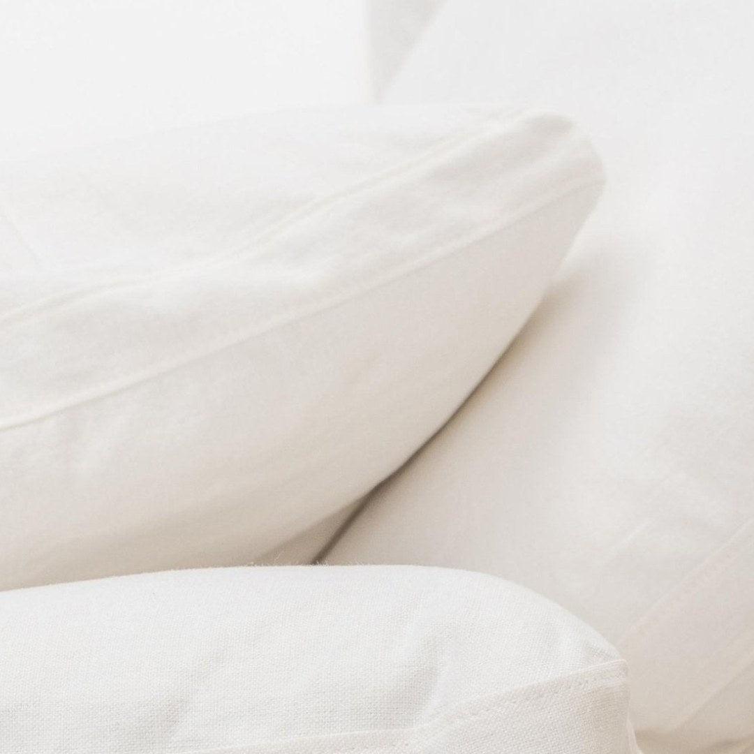 Close-up of Feather Modular Cloud Sofa cushions in white linen fabric, showcasing plush comfort and premium materials. Perfect for modern living rooms in UAE.