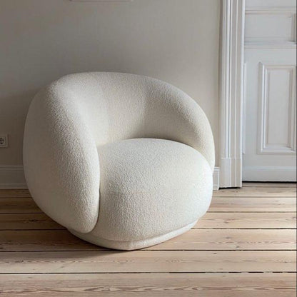 Cloud Boucle Armchair in white boucle fabric with a curved backrest, shown in a modern interior setting, perfect for stylish homes in the UAE.
